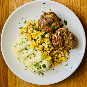 Meatloaf, mashed potatoes and corn.